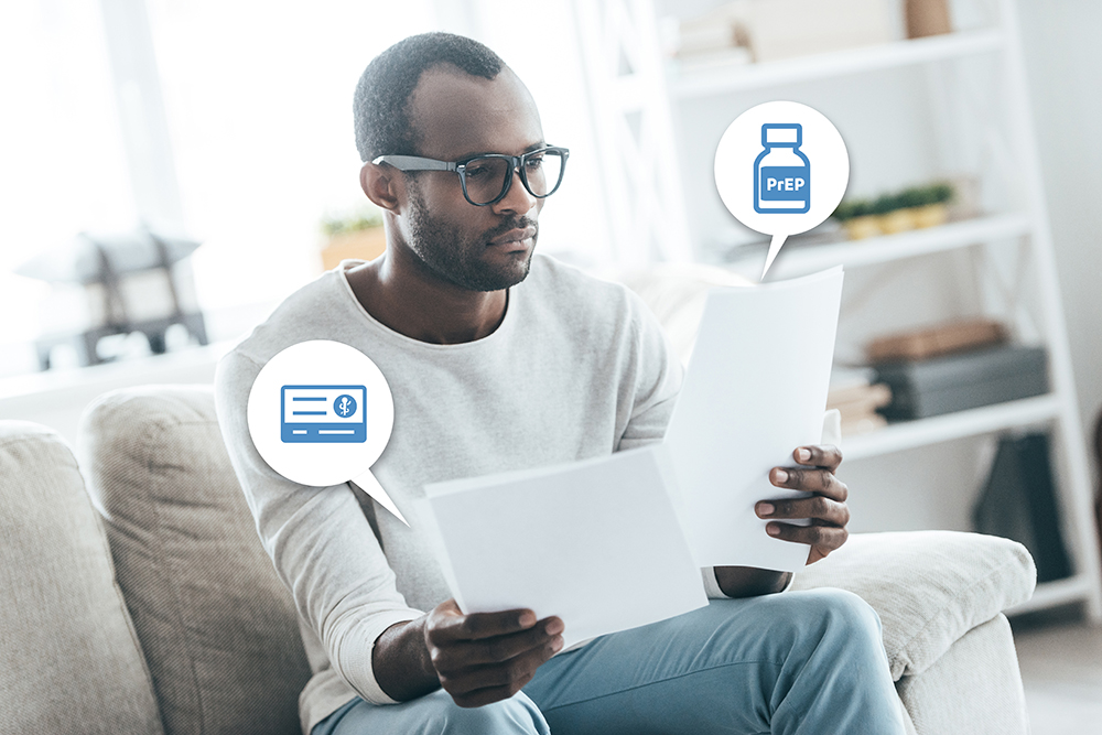 black young adult male looking at paper form about health insurance and pre-exposure prophylaxis