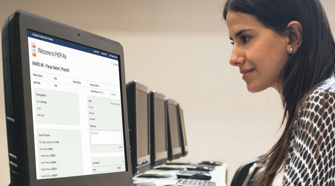 smiling woman looking at computer screen displaying PrEP-Rx Web-based panel management tool