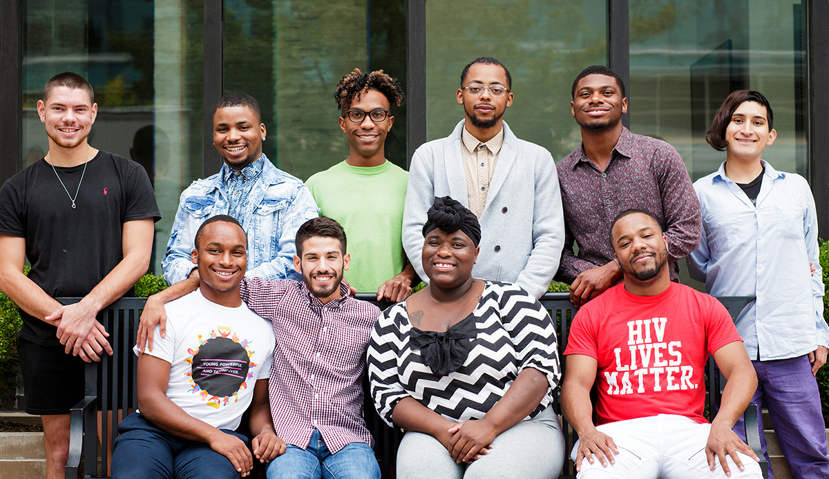 Diverse group of young people posing and smiling for National Youth HIV/AIDS Awareness Day