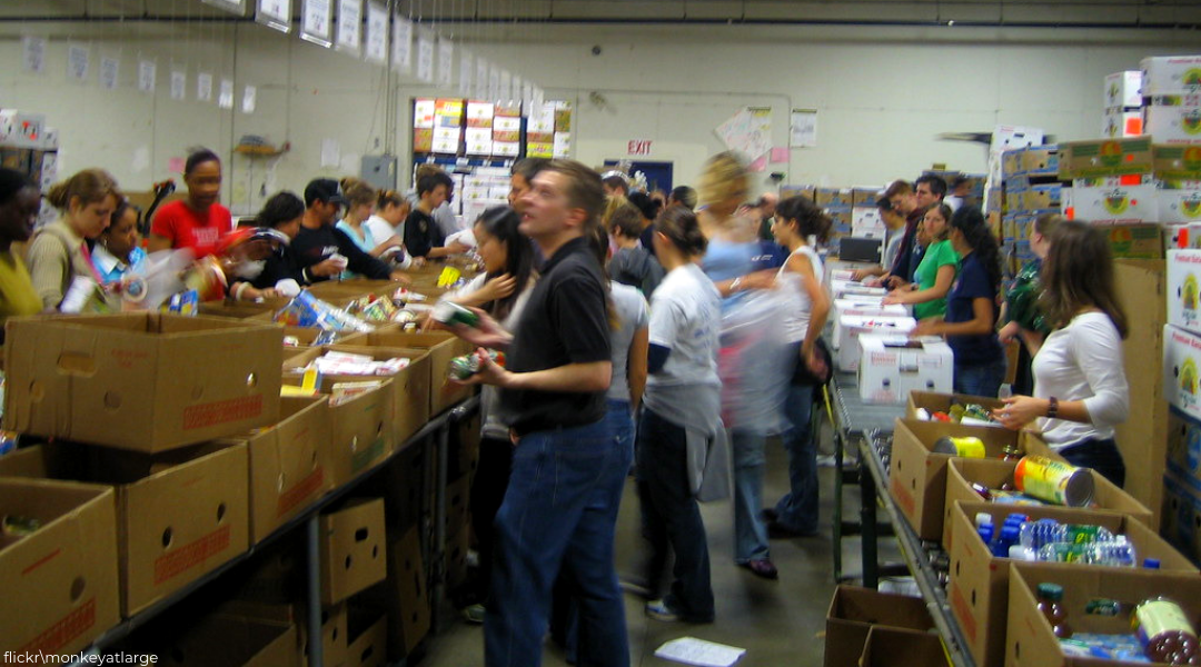 motion blurred photo of people sorting food at food bank