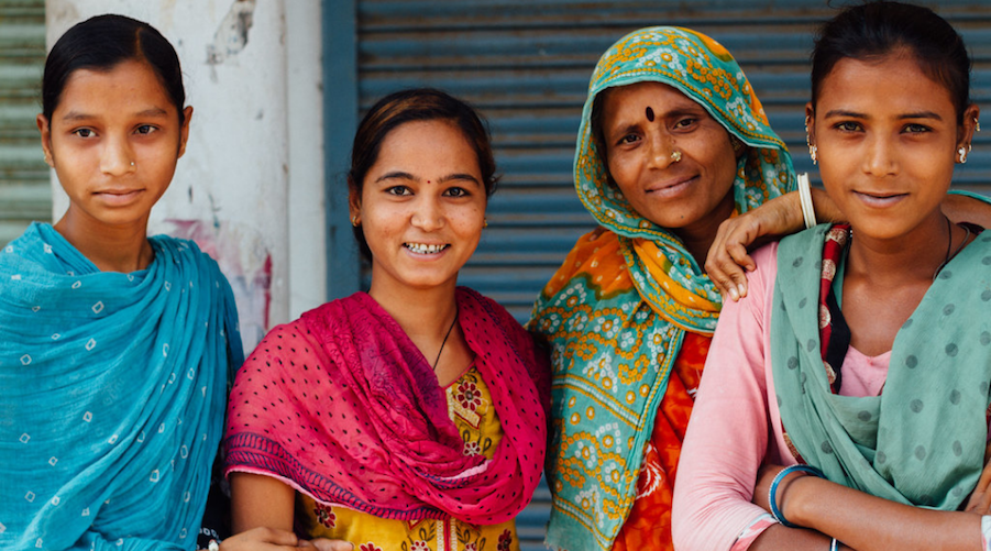 A family of four Indian women standing together