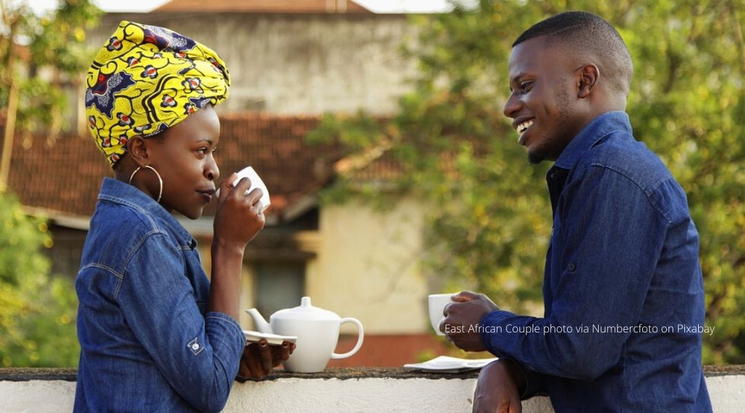 A female and male east african couple drinking coffee together