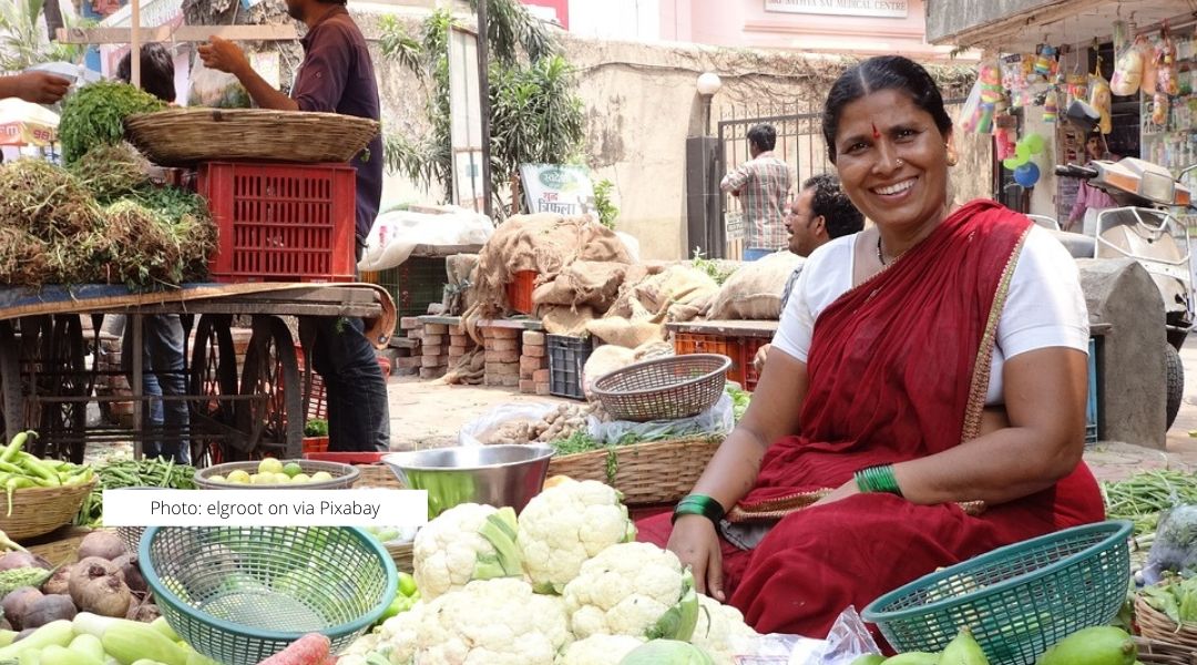 Indian woman at a outdoor farmer's market.