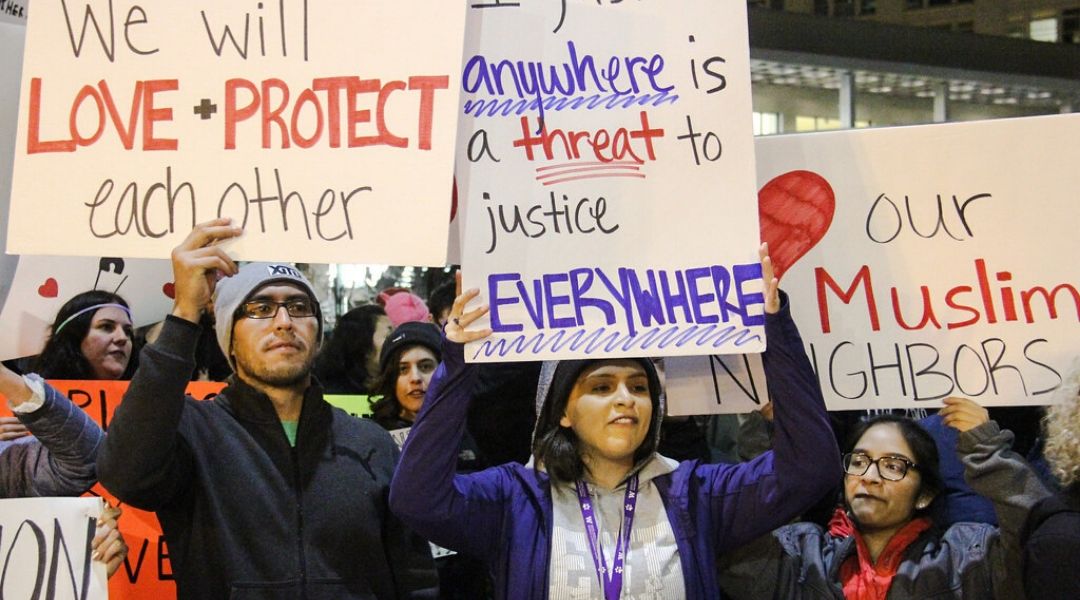 A group of immigration activists carrying signs of support and peace