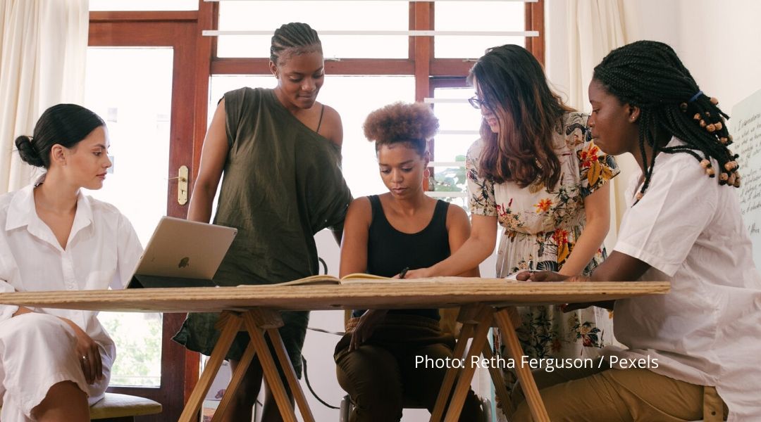 A group of professional women collaborating on a project