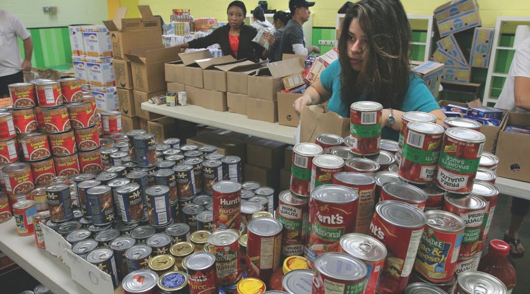 A food bank volunteer bagging groceries