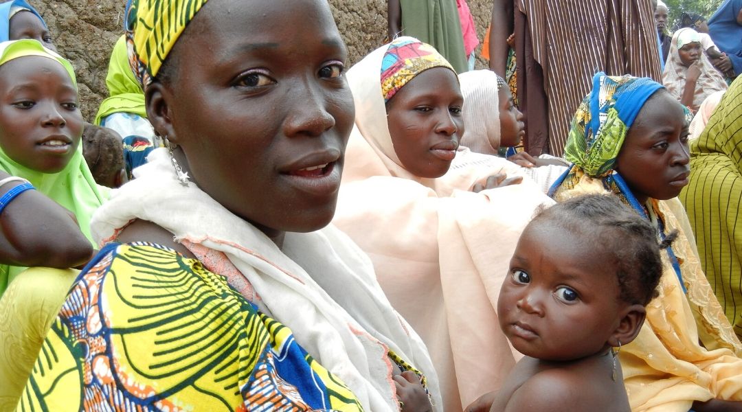 A mother and child pose for a camera