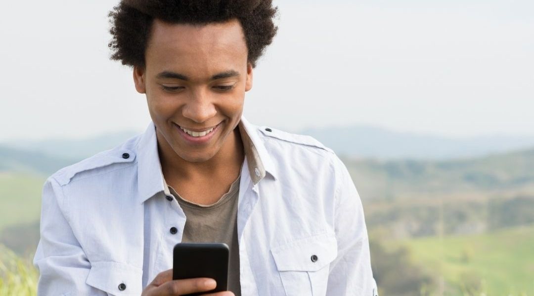 A youth is hypnotized by a smart phone