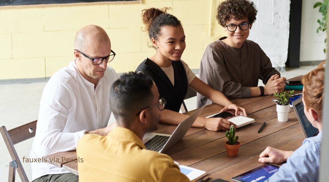 A diverse group works on problem solving together