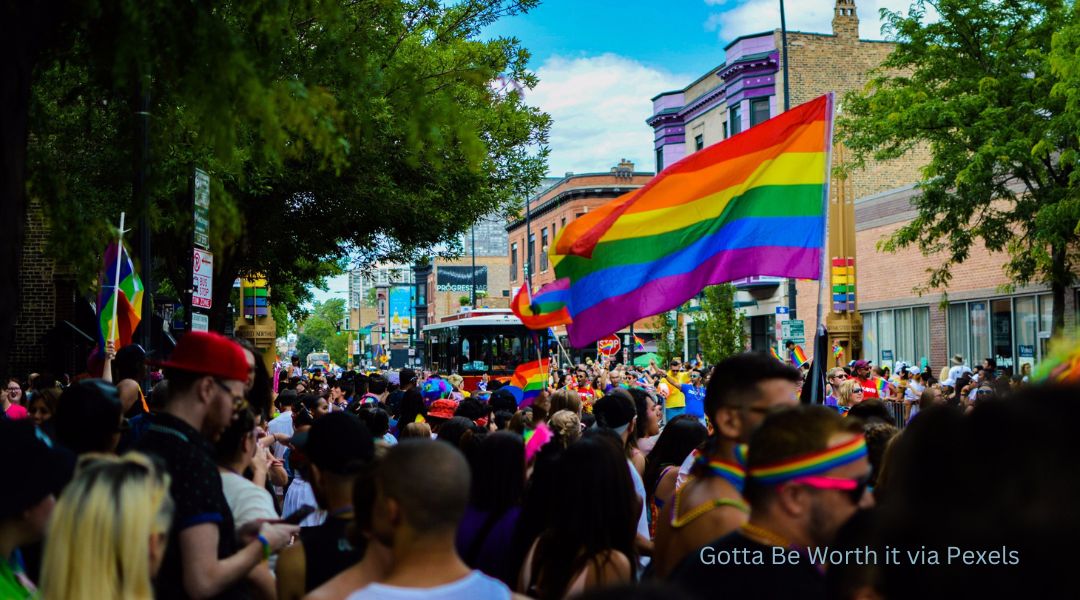 A pride event with rainbow flags waving